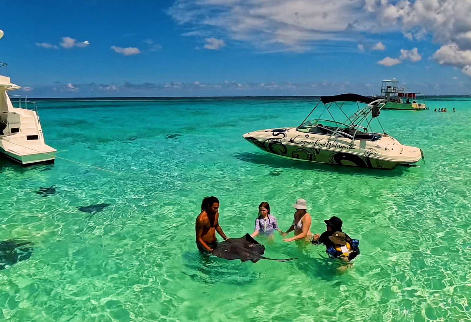 Family enjoying a Grand Cayman charter boat swim during the summer