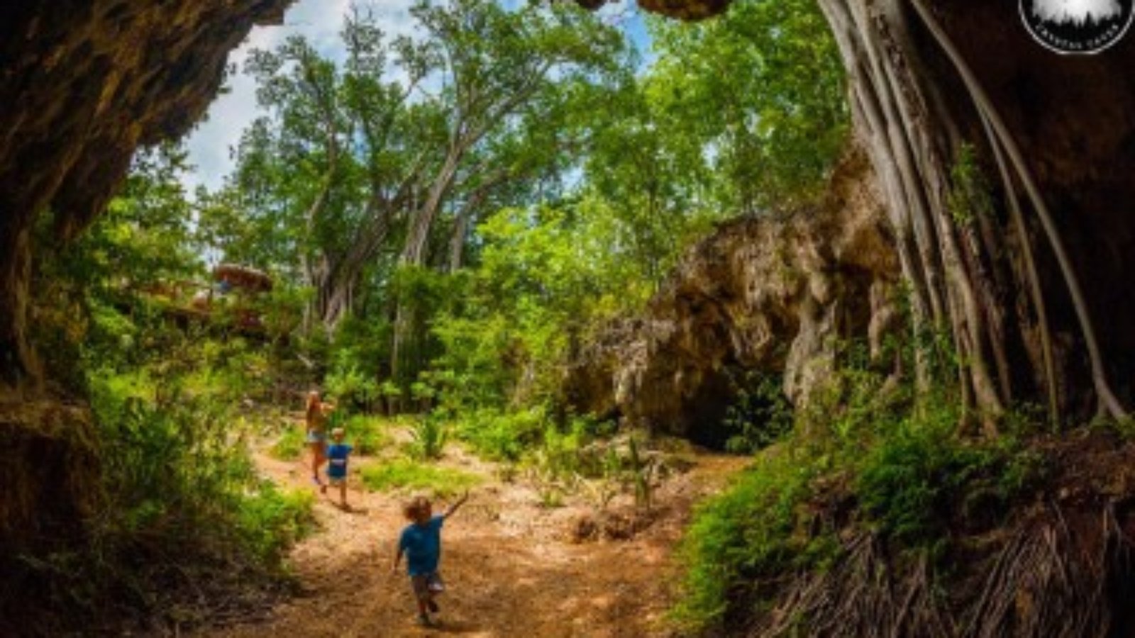 Cayman Kind Watersports boat cruising past coral reef barrier
