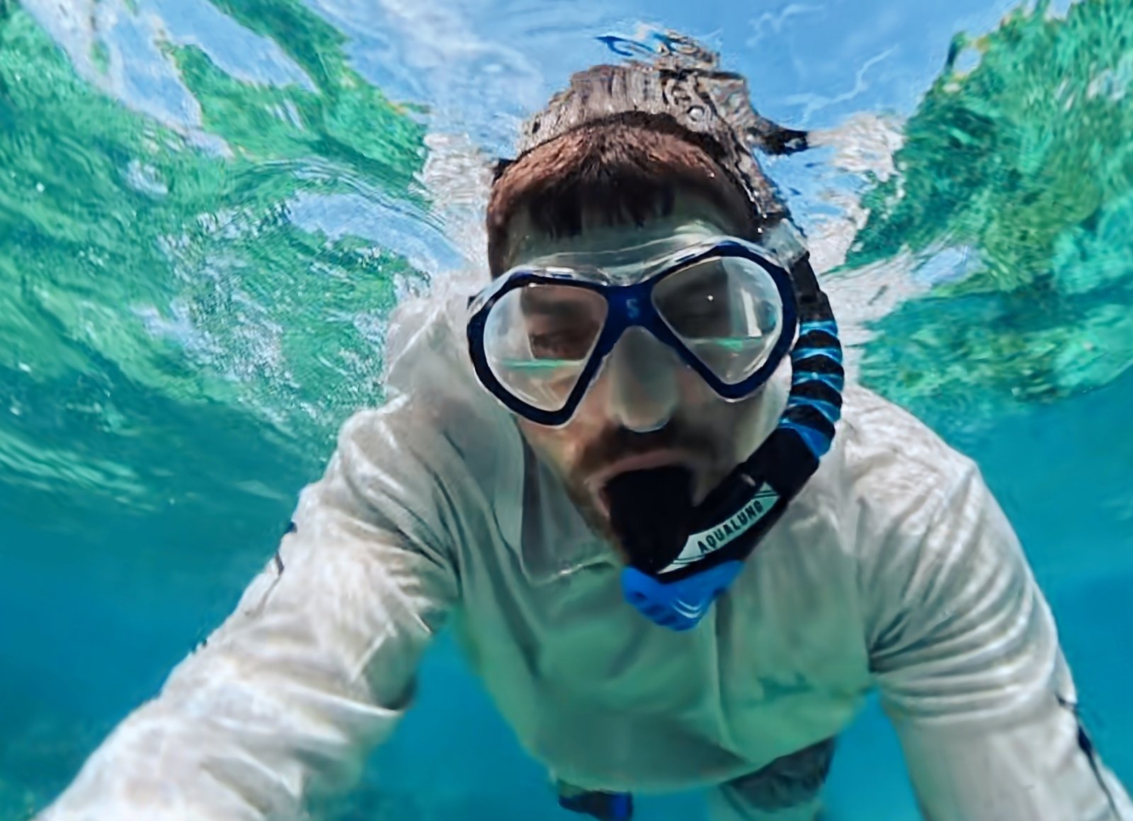 Snorkeling with colorful tropical fish during a customized Grand Cayman boat tour